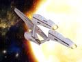 Star_Trek_USS_Enterprise_Traveling_Around_The_Sun_freecomputerdesktopwallpaper_p.jpg